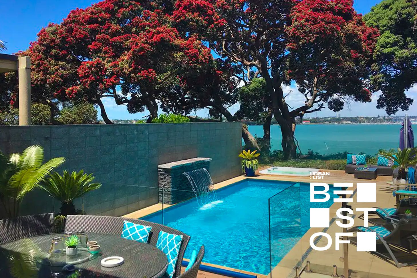 Dining table with pool (complete with fountain), spa pool and view of the sea.